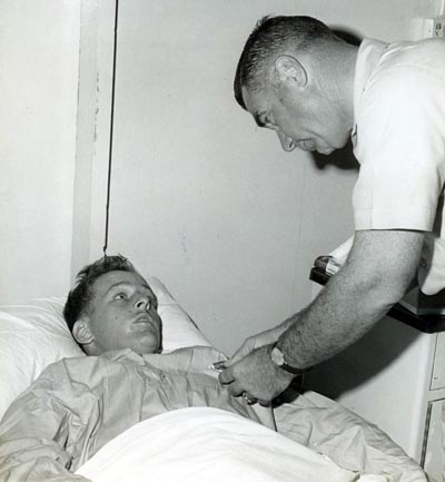 A2C Simmons, Russell, wounded in action on 4 Dec 1966, is being presented the Purple Heart at U. S. Army 3rd Field Hospital by Col Grover K. Coe, Tan Son Nhut's Base Commander.