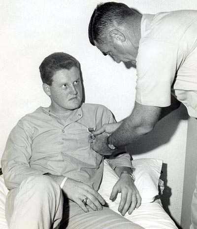 A2C Davis, Lyle K., AF14861942 wounded in action on 4 Dec 1966, is being presented the Purple Heart at U. S. Army 3rd Field Hospital by Col Grover K. Coe, Tan Son Nhut's Base Commander.