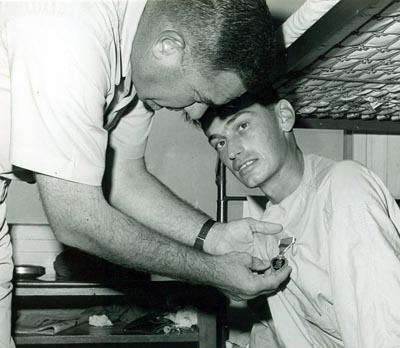 
SSgt Habecker, Barry L., AF13546189, wounded in action on 4 Dec 1966, is presented the Purple Heart at U. S. Army 3rd Field Hospital by Col Grover K. Coe, Tan Son Nhut's Base Commander.