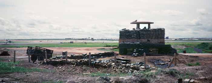 3. Biên Hòa Air Base: Runway bunker. I believe I caught an F-100 taking off over on the extreme left-center of the frame. On magnification it appears that the F-100 in this photo has wheels down and canopy up and people walking around it. I think that means they are working on it, though I have no idea why ther're are doing so on the West end of the taxiway.