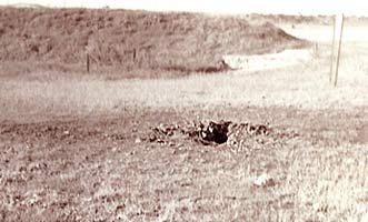 Photo Right, by Paul Huff, 6251st SPS:122mm crater, taken AUG 1 '72, 150 feet or so behind Bullseye-7 in Bomb Alley (north perimeter), just missing a revetment full of 500 pounders.