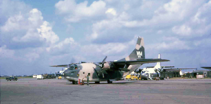 Bien Thuy Air Base flight line. C-123 prepares to start second engine, as crewman standsby with extinguisher. MSgt Summerfield: 12
