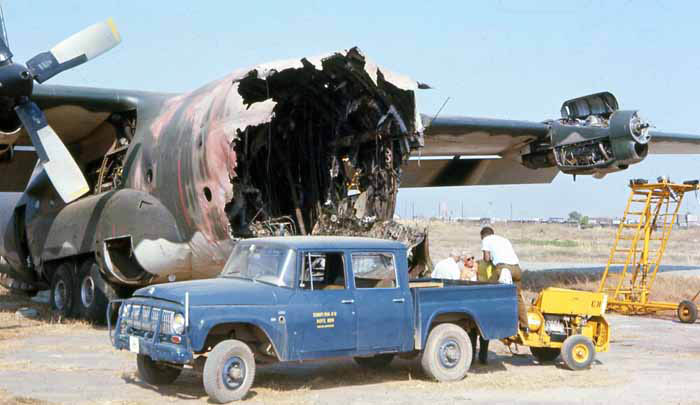 Bien Thuy Air Base. Aircraft mechanics and crews inspect destroyed C-130. Parts-is-parts. Damaged pickup tows generator. MSgt Summerfield: 32