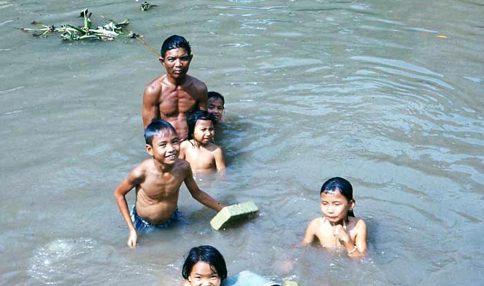 Bien Thuy Air Base. River village kids take a bath. Dad's tired of getting splashed. Mamasan gets a few minutes peace. MSgt Summerfield: 09