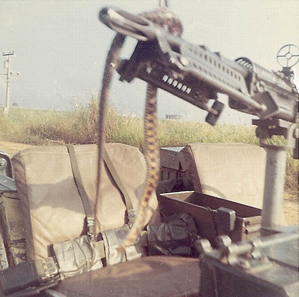 11. BT Air Base: Local snake wrapped on a mounted M-60. Photo by Jaime Lleras. 1970.