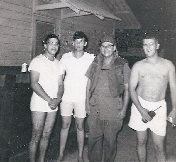 14. BT Air Base: Jaime with two other brothers and the Base Chaplain (in uniform) after a mortar attack on 9/1/70. Photo by Jaime Lleras. 1970.