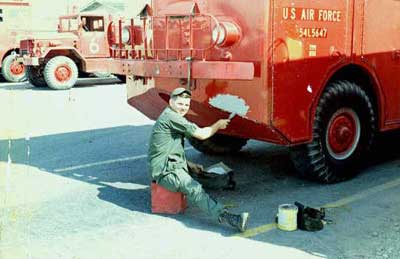 2. Me patching up shrapnel holes from a mortar attack 1969.