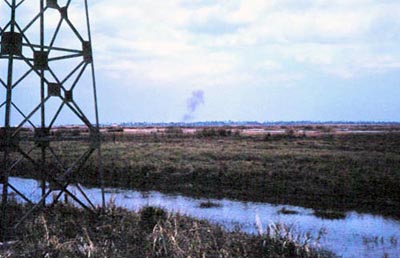 2. Bình Thủy Air Base: Perimeter Tower. Possible shell burst on center-horizon. 1968. Photo by: Mel Hecker, LM 72, DN, 366th SPS; DET CB; DH, 1/620th TCS; BT, 632nd SPS. 1967-1969.