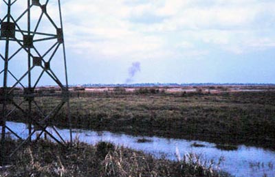 2. Bình Thủy Air Base: Perimeter Tower. Possible shell burst on center-horizon. 1968. Photo by: Mel Hecker, LM 72, DN, 366th SPS; DET CB; DH, 1/620th TCS; BT, 632nd SPS. 1967-1969.
