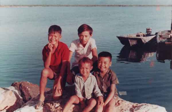 12th SPS Neptune Boat Dock. Myca boys setting on rock, 1969-1970