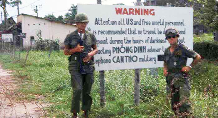Can Tho area. Sign Reads: WARNING Attention all US and free world personnel. It is recommended that no travel be conducted from this point during the hours of darkness without contacting PHONG DINH advisor team. Telephone CAN THO military police. MSgt Summerfield: 10