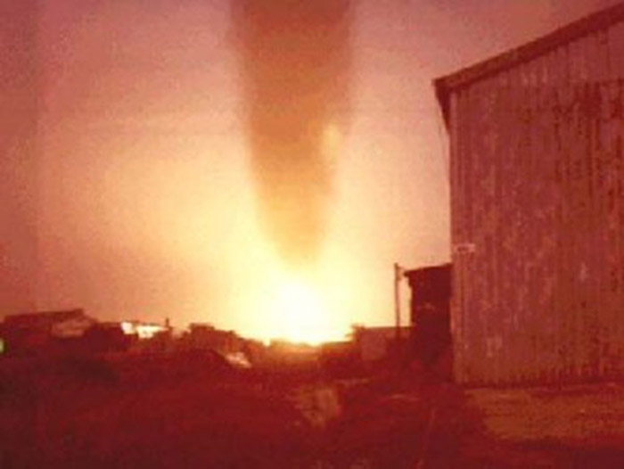 8. Đà Nẵng Air Base: Oil Dump ablaze with a geyser column of fire and smoke blasting upwards. Photo by Alan Ellison, 1968.