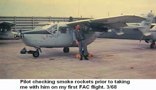 Đà Nẵng Air Base, SVN: USAF Pilot checking smoke rockets prior to taking Bard Deal, 366th SPS, K-9, with him on his first FAC flight. Mar. 1968.