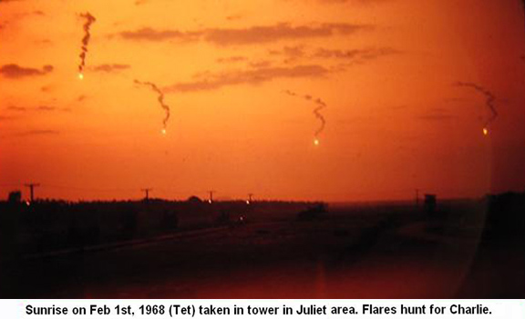 Đà Nẵng Air Base, SVN: USAF. Sunrise Feb. 1, 1968 TET, photo view from 366th SPS tower in Juliet Area. Flares hunt for Charlie. © 2011 by Bradford K. Deal.
