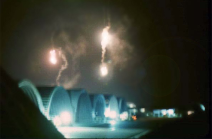 1. Đà Nẵng Air Base: Flares drift over flight line ramp hangars. Photo by Chris Butler, 1971.