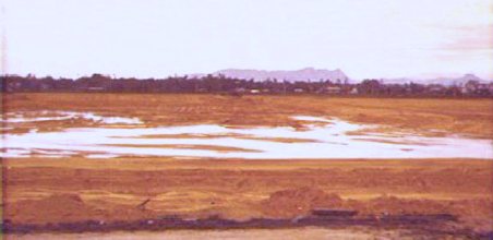 [42] Looking South from the Mortar Pit. I use to watch B-52 Bombers' strikes walk along the mountain in the central background.