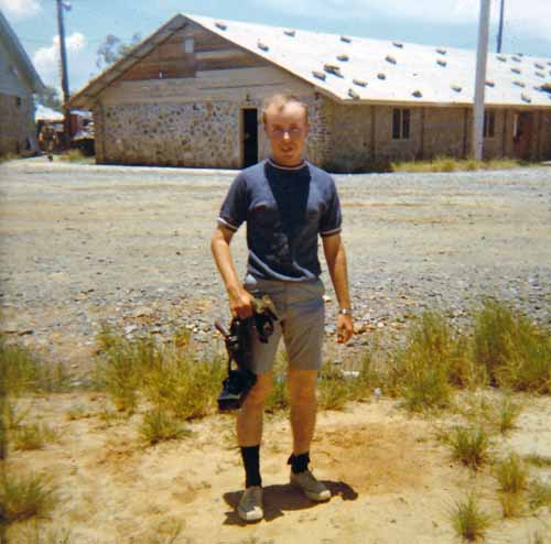 9. Đà Nẵng Air Base: 366th SPS, Duane Snow with Armory behind him and carrying his leather gear with .38 revolver. Photo by Konrad F. Kottke, 1971-1972.