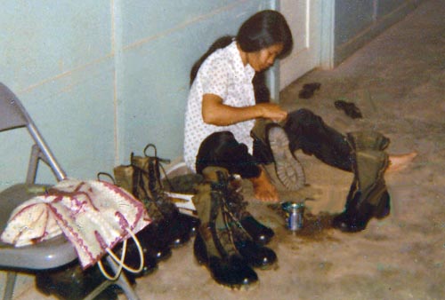 12. Đà Nẵng Air Base: 366th SPS, My Hooch girl working on shining boots. Photo by Konrad F. Kottke, 1971-1972.