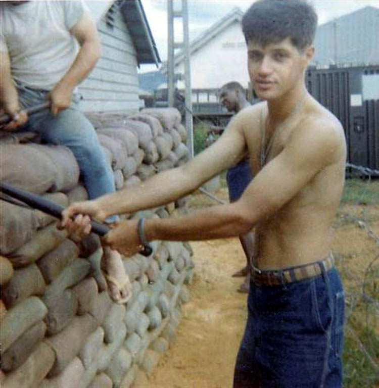 9. Đà Nẵng AB, 366th SPS. Ralph packs down double-sandbag wide wall around huts. Photo by: Ralph Manganiello Jr. 1966-1967.