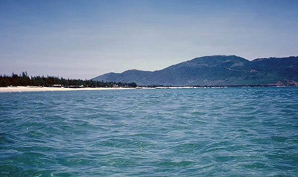 32. China Beach, Đà Nẵng:  Wading 200 yards off shore and still at waist-deep! Monkey Mountain in background.