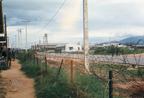 10. Đà Nẵng AB, Tent City: Airman come outside to watch, having heard the bombs exploding and aircraft buzzing around. 1965.