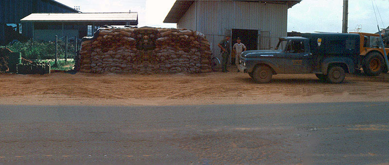 7. Đà Nẵng AB, Tent City: Directly across the POL Road from the AP Post is the POL bunker and pump station. The day after the stand off mortar attack the road's crater is patched, the pickup truck replaced, and an AP is at the pump station. 1966.