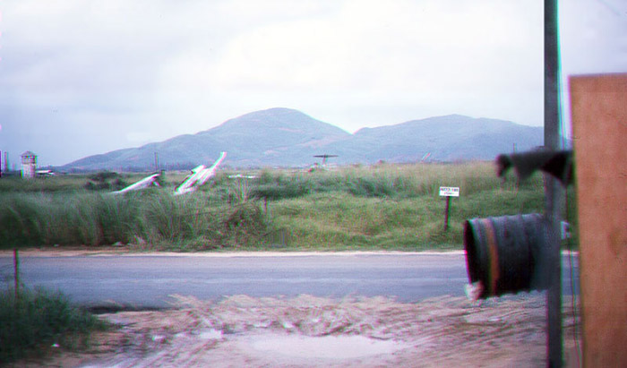 12. Đà Nẵng AB, Tent City: POL Road runs N/S passing the AP Tent City's West AP Access post. Across the street in the field is a growing boneyard of destroyed aircraft debris. 1966.