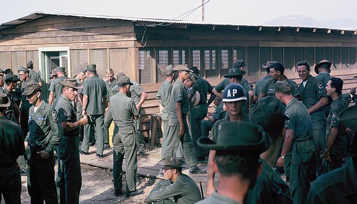 14. Đà Nẵng AB, Tent City: AP squadron members await start of dedication at Day Room entrance. 1966.