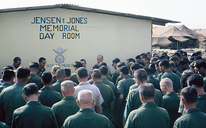 17. Đà Nẵng AB, Tent City: Col Eisenhower, Đà Nẵng AB Commander, and LTC Arthur G. Phillips Jr., 35th APS Commander join Chaplin as he says a prayer. Airmen and focused and silent during the ceremony. 1966.