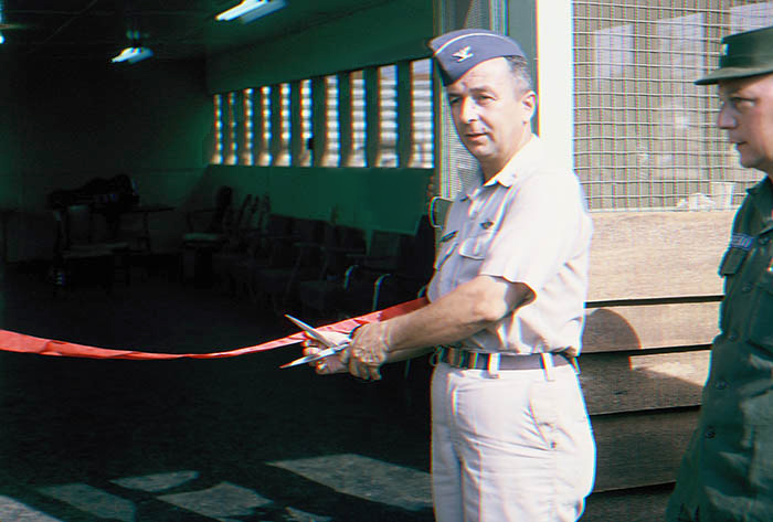 19. Đà Nẵng AB, Tent City: Base Commander, Colonel Eisenbrown cuts red dedication ribbon, officially opening the Day Memorial Room. 1966.