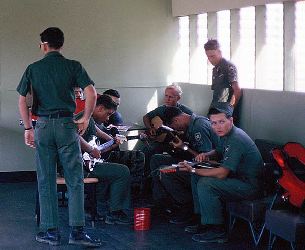 27. Đà Nẵng AB, Tent City: Close up of guitar players. 1966.