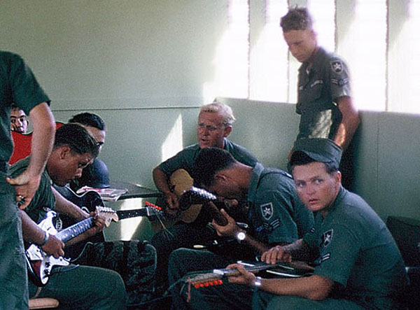 28. Đà Nẵng AB, Tent City: Airman sings a meloncoly song. 1966.