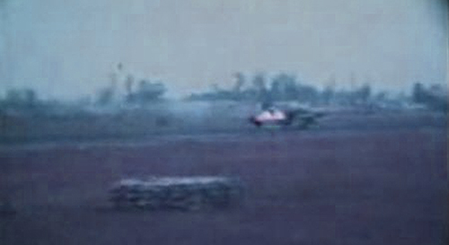 25. Đà Nẵng AB, K-9 Growl Pad: F-4 Phantom take off with afterburners shattering bedrock. K-9 fighting-hole in foreground. 1965.
