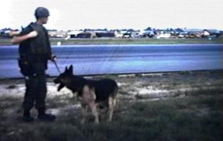 27. Đà Nẵng AB, K-9 Growl Pad: Don Poss is wearing a 25 pounds flak vest designed for WWII bombers. Never wore it again! 1965.