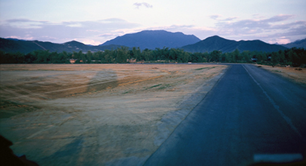 37. Đà Nẵng AB, K-9 Growl Pad: View from K-9 posting truck N/B perimeter road, ready to curve W/B at the Air Base's north perimeter. 1965.