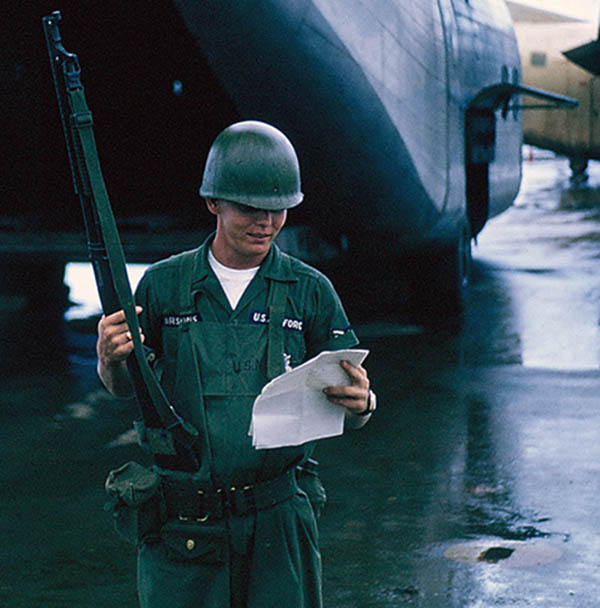 7. Đà Nẵng AB, flight line: A2C Parsons, wearing USN raingear. 1965.