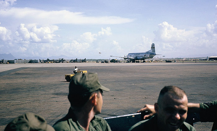 9. Đà Nẵng AB, flight line: AP Truck posting Airmen along C-124 parking area. 1965.