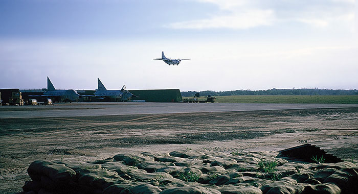 28. Đà Nẵng AB, flight line: C-123 landing. South end of runway. To the left and right of the parked F-102s is where sappers penetrated ARVN guarded perimeter, 1 July 1965. 1965.