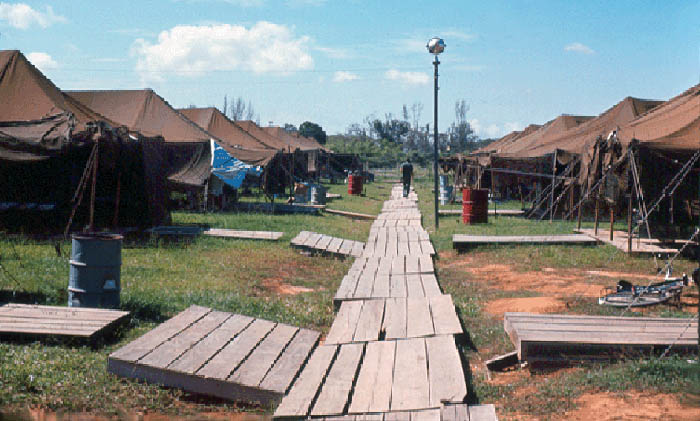 3. Đà Nẵng AB, Tent City: Tent City began parallel to the west cantonment road on the east, flight line road on the west, POL service road on the north, and closing on the south to a triangle shape with a diagonal road. My tent was row-1, number-2. 1965.