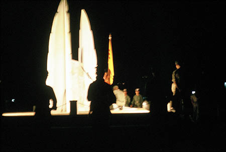 For a major dedication ceremony, attendance was poor. True, there were SVN flags, banners, spotlights sweeping a starry night sky, bonfires, and civilians standing around... someone got a medal, and a Vietnamese civilian gave a speech which no one applauded. When it was over, the crowd faded quietly into the night. The memorial, Uplifted Wings, was touted as an eternal flame... but sometime during that dedication night, the flame went out... and... was never re-lit.