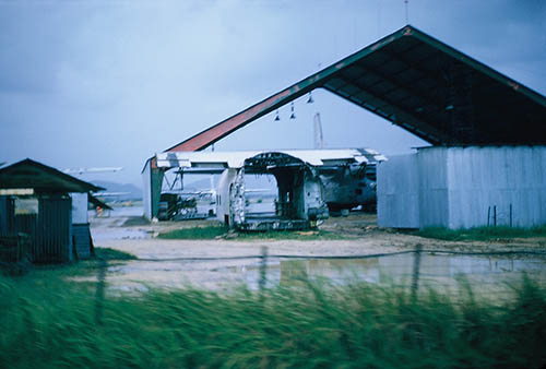 26. Đà Nẵng AB, Tent City: Looking west from Tent City's cantonment area, you could see a growing aircraft boneyard pile of rubble, along with part of a C-130 destroyed and now canabilized from the 1 July 1965 sapper attacked that Sgt Terance Jensen was KIA in. 1965.