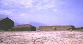 Da Nang AB, Aircraft crew and flight line tents, with concrete revetment in background.