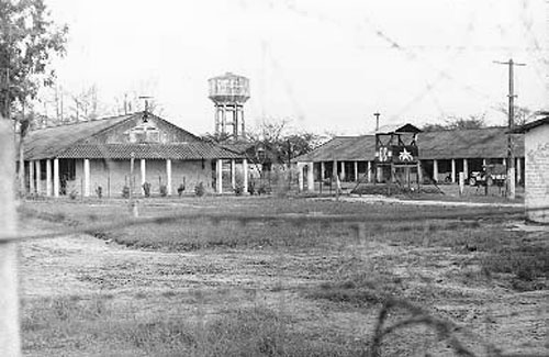 12. Đà Nẵng AB, VC-NVA POW Camp near main gate. QC Tower in camp. Water Tower in background. 1966-1967. Photo by: Ron Westering, LM 431, DN, 366th SPS; DET MM, 1/366th SPS. 1966-1967.