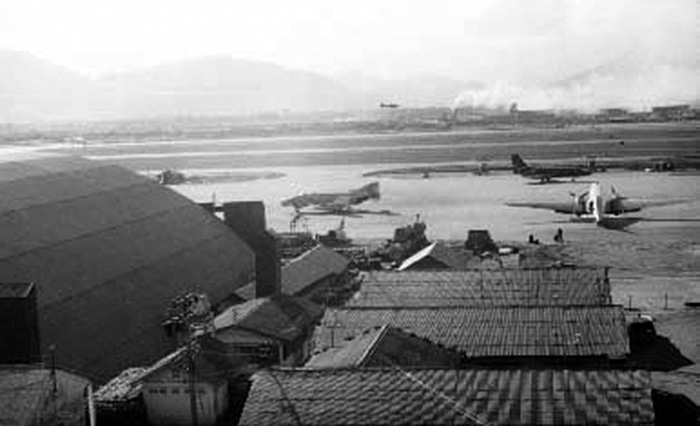 5. Đà Nẵng Air Base: 366th SPS, Mid flight line view to west, with part of Freedom Hill 327 visible. Both runways are fully constructed and active. Photo by Ron Westering, 1966-1967.