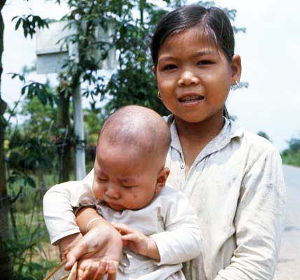 Dai Tan village girl carrying infant. MSgt Summerfield: 15