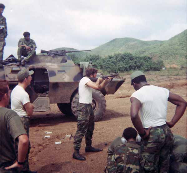 Photo #11 (Nha Trang): This is me getting ready to go on duty. I must have been assigned to the Main Gate as I don't recall helmets being worn on any other post. This was taken behind the hooches prior to the move to the concrete barracks. At the time of this photo we maintained our weapons in the hooches.