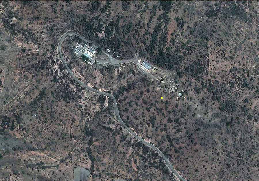 6. Google Satellite image (current): Nui Dat hill, overhead view. Yellow dot marks 180.30 meters high. 