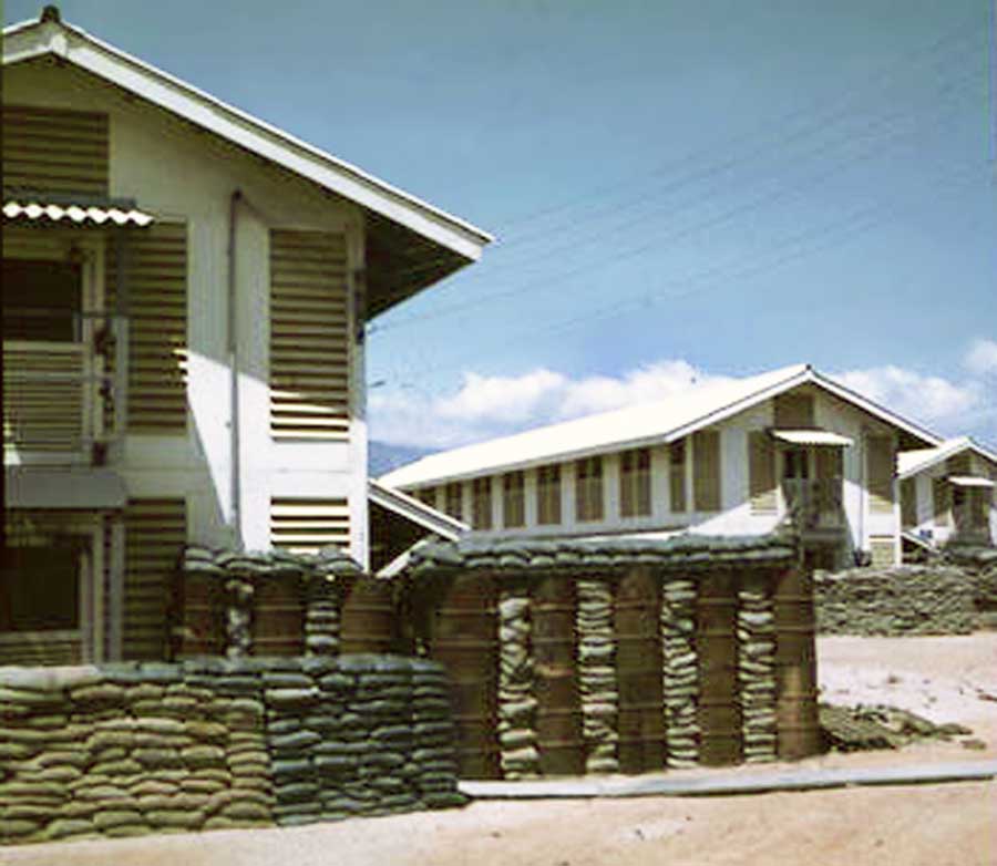 11. Nui Dat: 35th SPS. With barracks construction, followed sandbag and bunkers details. I wonder what the barrels had contained? Photo by Stan Reeves, ND 1967.