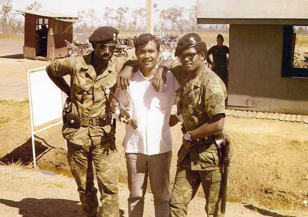 2a. NKP Main Gate: Sgts Davenport and Clement, with the LE interpreter, Mr. Daisha (An Indonesian). Photo by: Roderick K. Duncan.