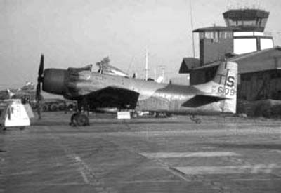 11. NKP Control Tower, above tail of parked A1E Spad. Photo by: unknown.